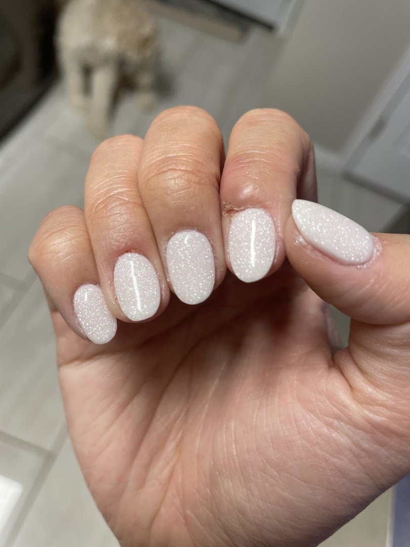 Nail salon interior with manicure stations and polish displays